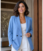 Women's light blue tailored double breasted blazer worn with a white top