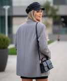 Women's slate grey double breasted blazer, side pose with hand in pocket