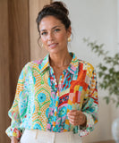 Women's linen shirt with aqua patchwork print styled with ivory trousers