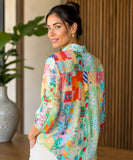 Back view of a women's linen shirt with aqua patchwork print