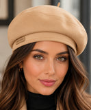 Woman wearing a camel structured twill French beret with a top stem