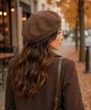 Woman wearing a mocha structured twill French beret with a top stem