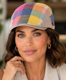 Woman wearing a multicolor patchwork plaid newsboy cap with a short structured brim