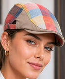 Close-up front view of the multicolor patchwork plaid newsboy cap