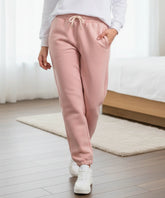 Close-up of hot pink sherpa-lined joggers showing the fabric texture