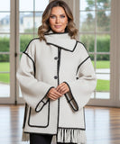 Woman wearing a wool cape coat in off white