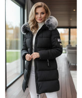 Woman wearing a long hooded parka coat in black