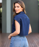 Women's cropped denim vest in blue, styled with high-waisted pants