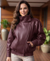 Woman wearing an asymmetrical leather jacket in burgundy