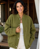Woman wearing an oversized boucle bomber jacket in olive green