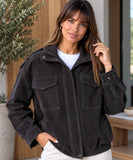 Women's oversized suede bomber jacket in charcoal worn with the zip open