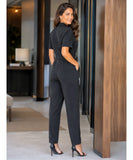 Women's black jumpsuit with closed back and tapered legs, back view