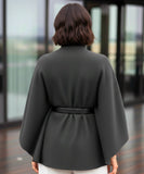 Women's charcoal grey mock-neck sweater poncho, styled look