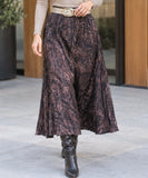Women's brown marble print midi skirt styled with a belt and boots
