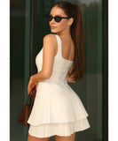 Women's tiered ruffle mini dress in white, side view