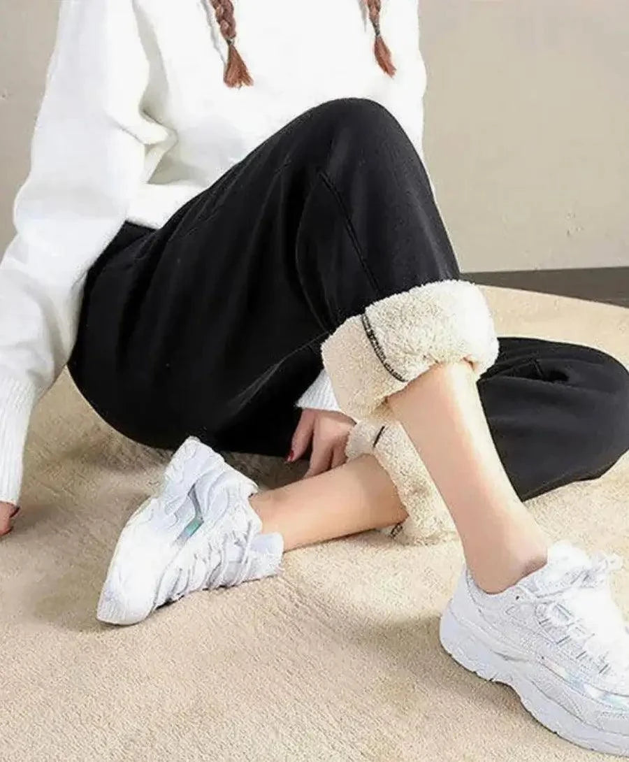 Close-up of black sherpa-lined joggers showing the soft knit exterior