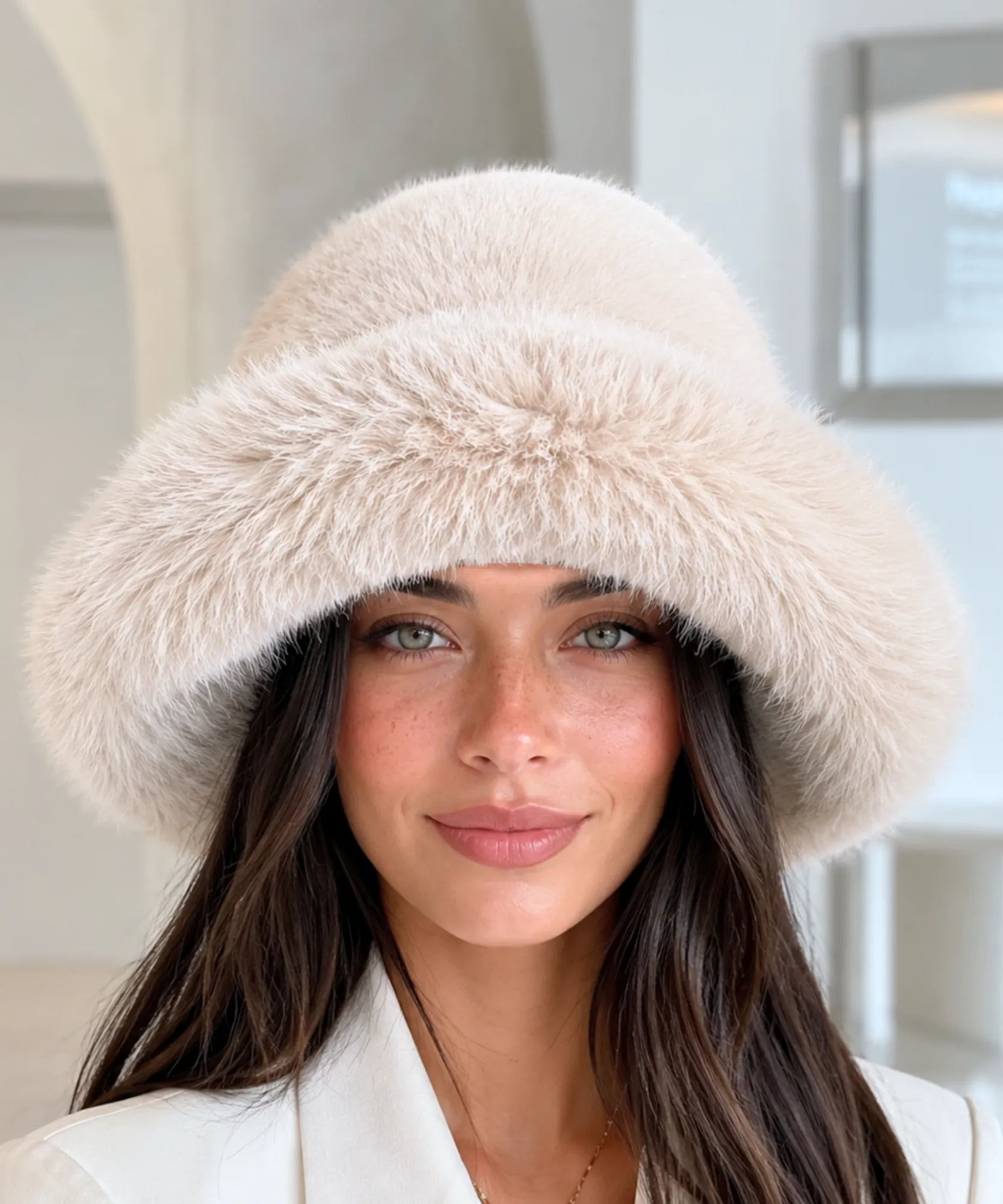 Ivory fur bucket hat with a structured brim, close-up view
