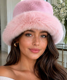 Woman wearing a Blush Pink fur bucket hat with a structured brim