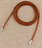 Women's thin rope belt in cognac vegan leather with gold metal tips