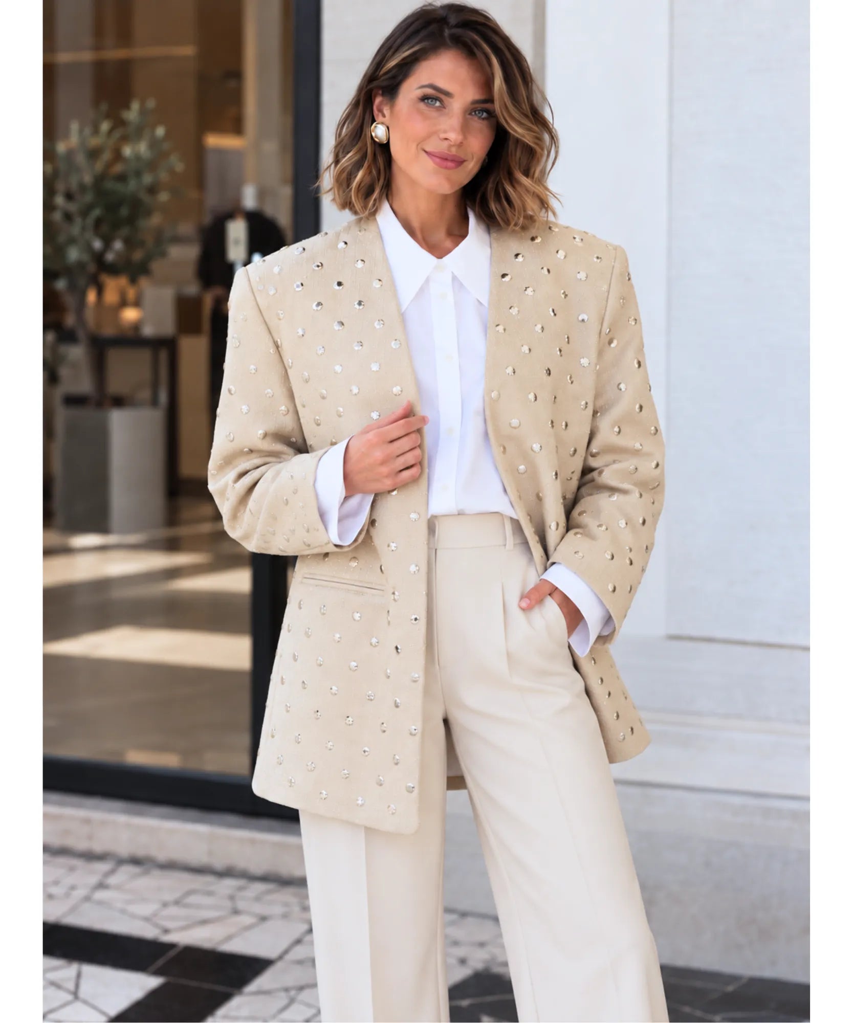 Beige oversized blazer with ivory pants and hands in pockets