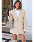 Beige oversized blazer styled with over the knee boots and a handbag