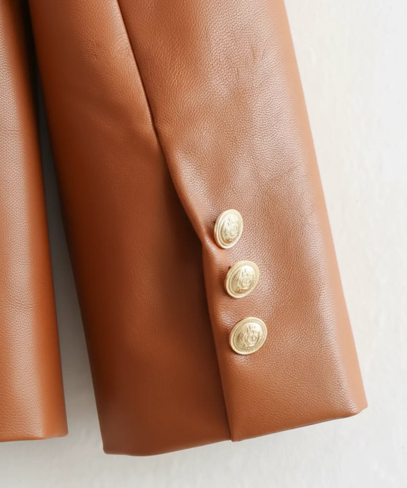 Women's leather blazer with gold buttons, lapel detail
