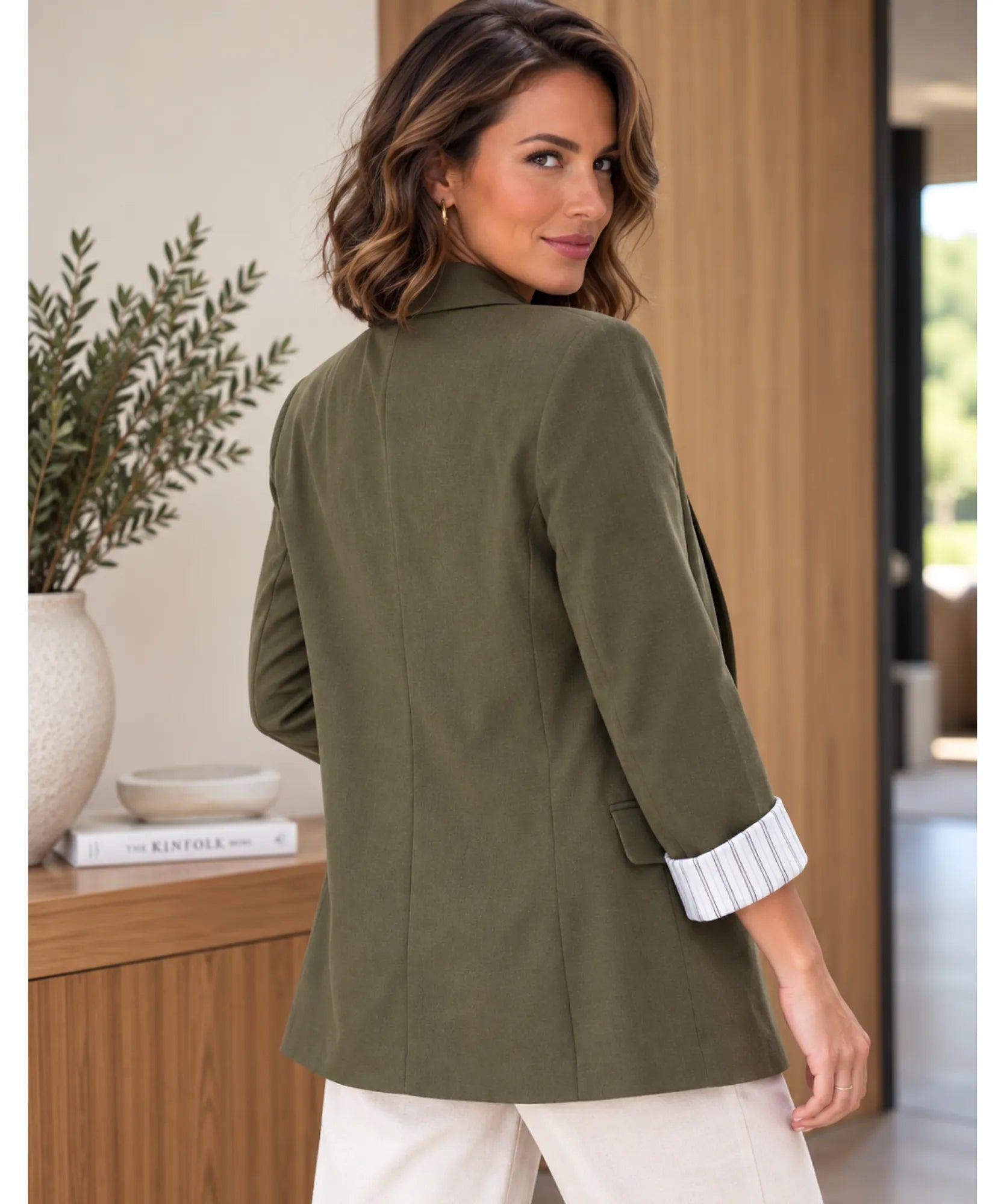 Back view of a women's olive green linen blend blazer with striped cuff lining