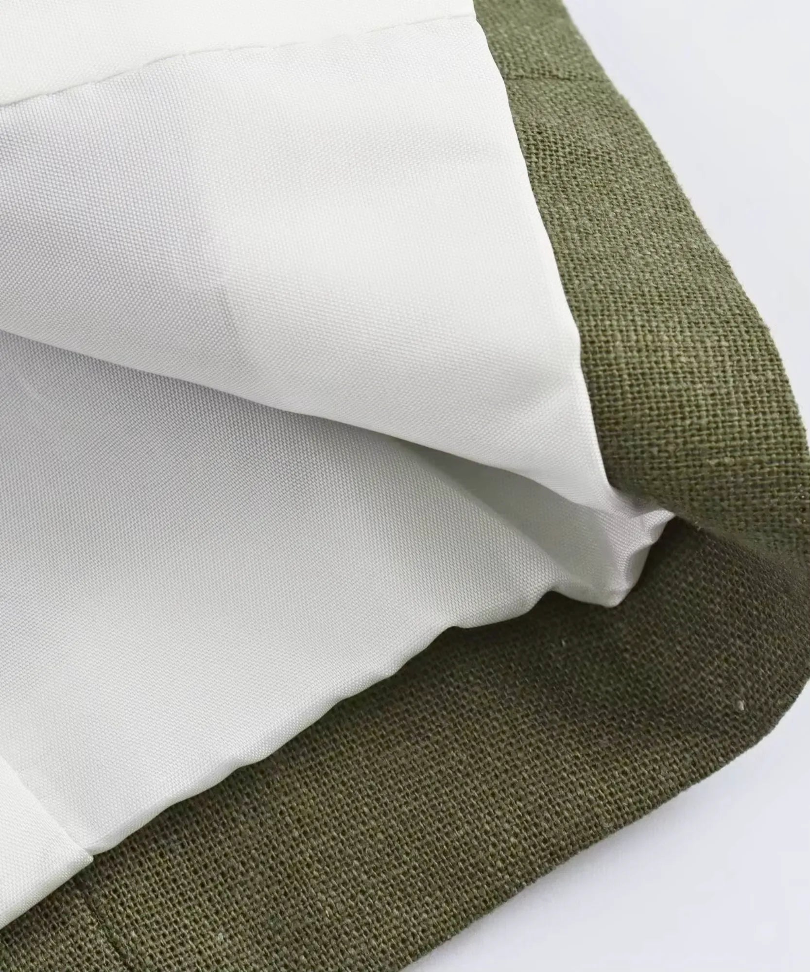 Interior lining detail of an olive green linen blend blazer