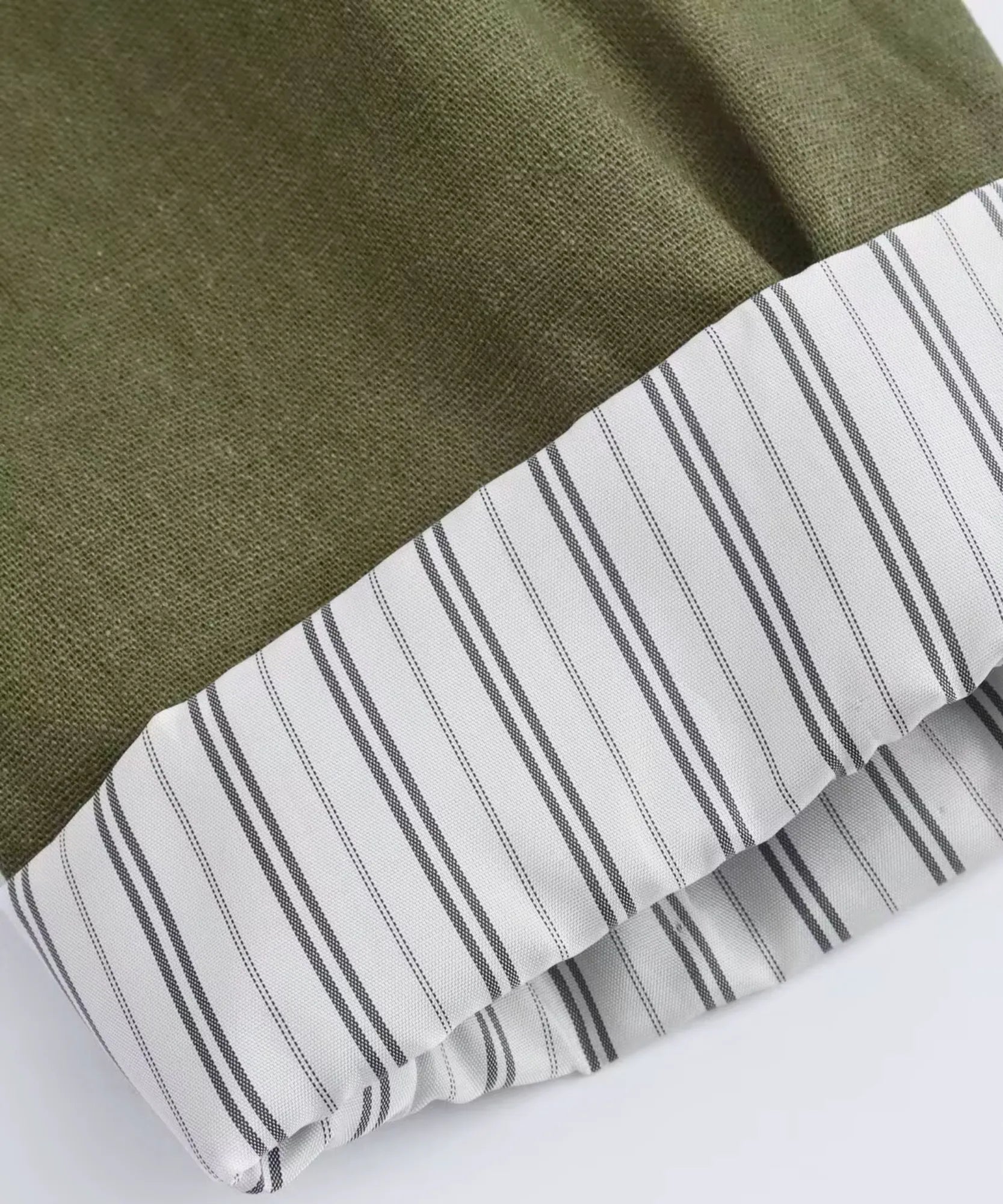 Close up of the striped cuff on an olive green linen blend blazer sleeve