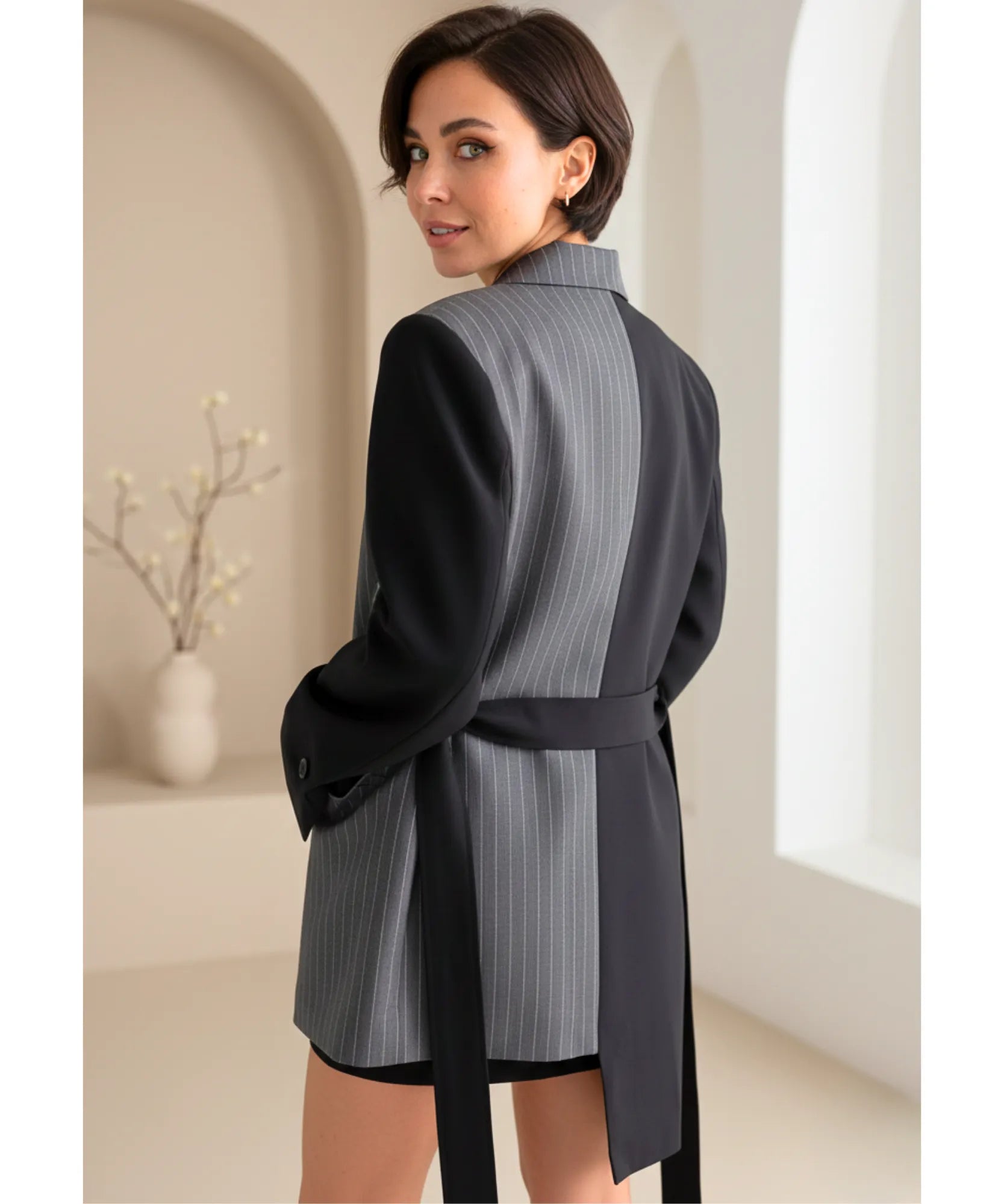 Back view of the pinstripe panel and tie belt on the black blazer