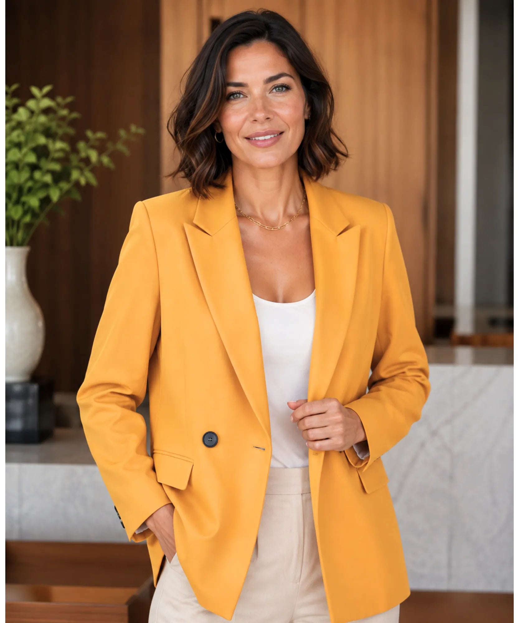 Women's marigold yellow double breasted blazer styled with a white top and cream trousers