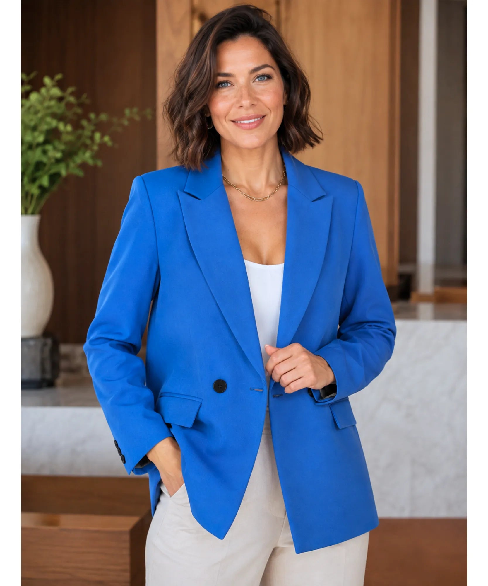 Women's cobalt blue double breasted blazer with front pocket, side pose