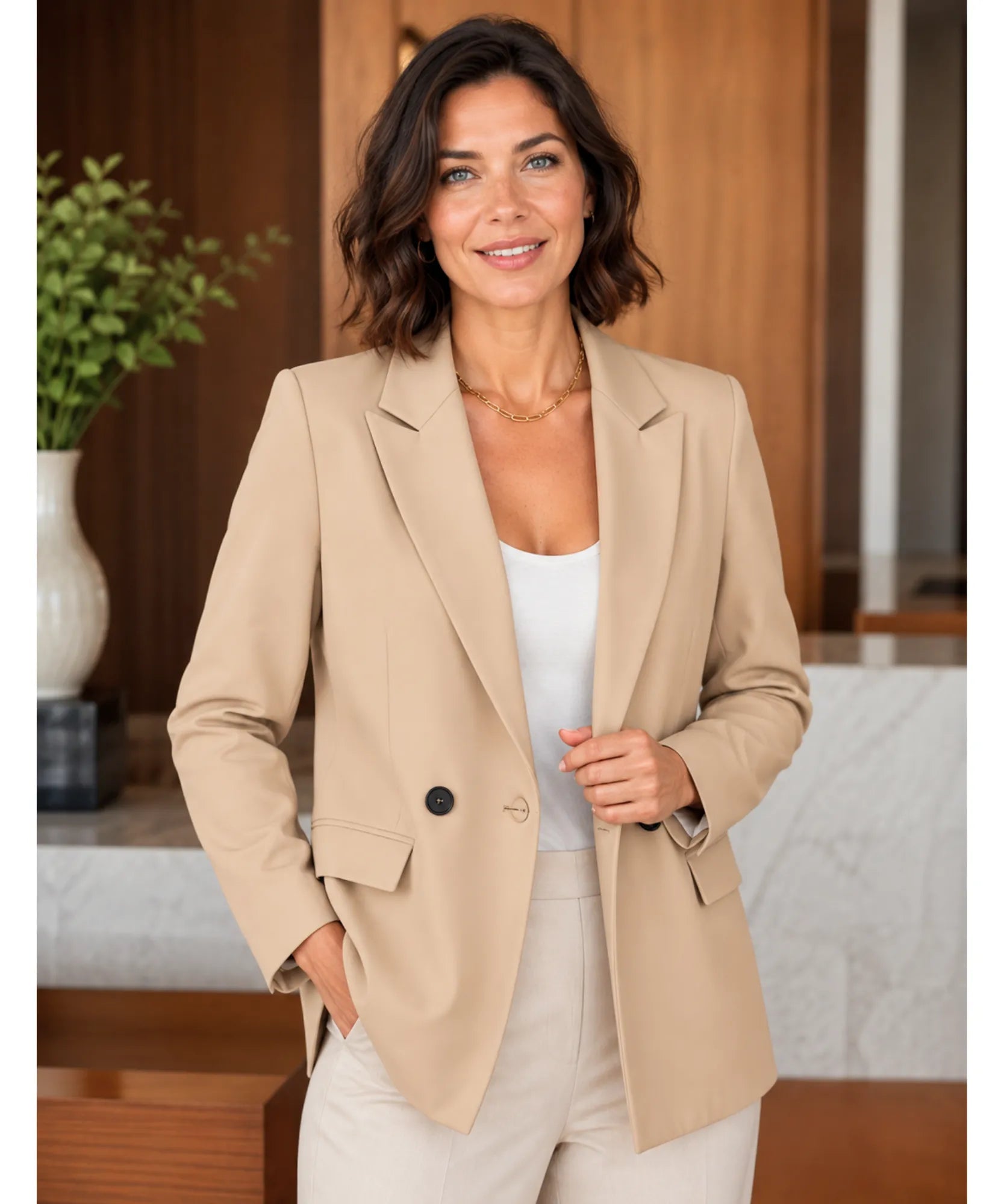 Women's beige double breasted blazer with a single visible button, front view