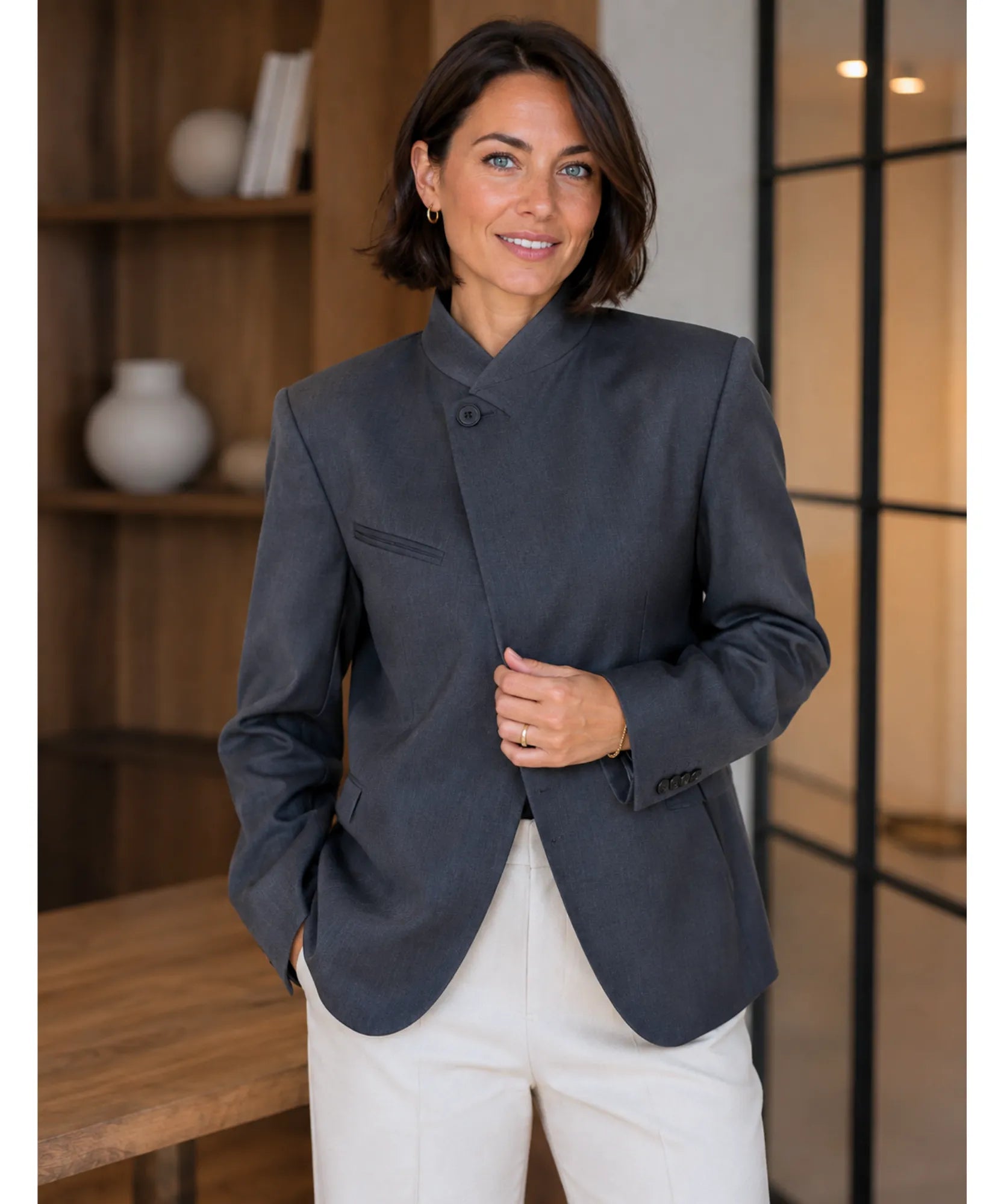 Women's grey asymmetrical blazer with high collar, front view
