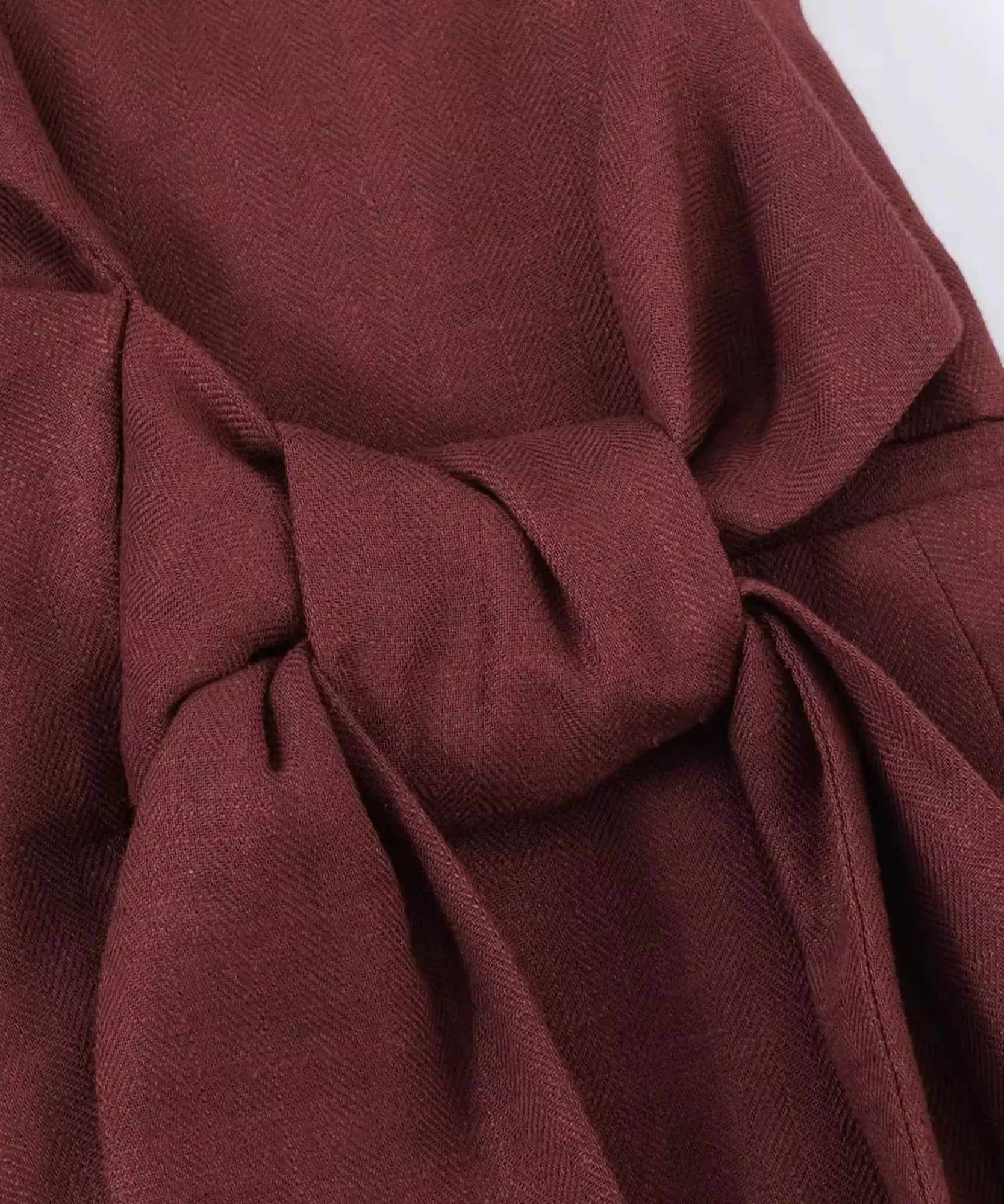Side tie belt detail on the Mahogany wrap blazer