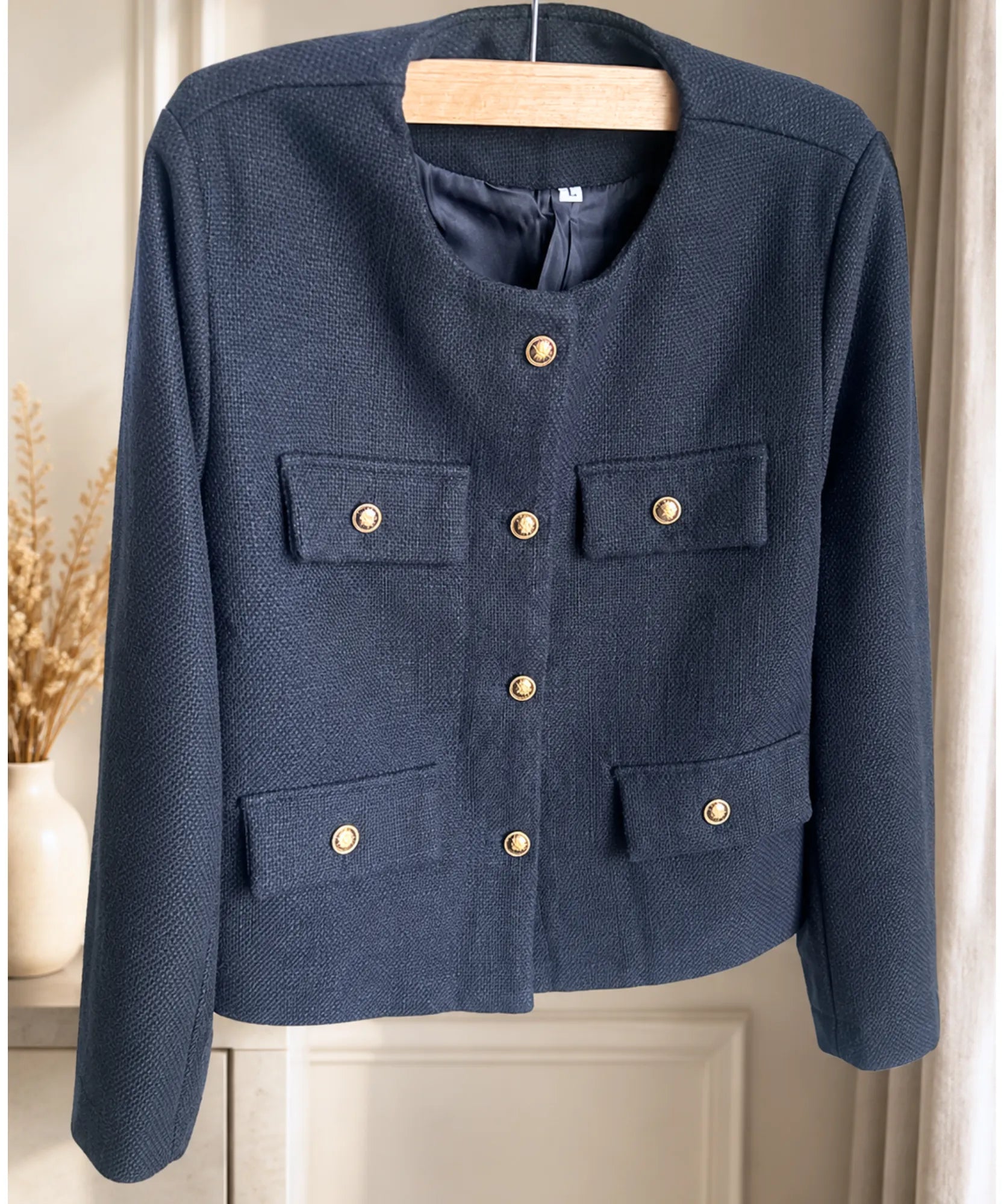Navy cropped tweed blazer on a hanger, front view