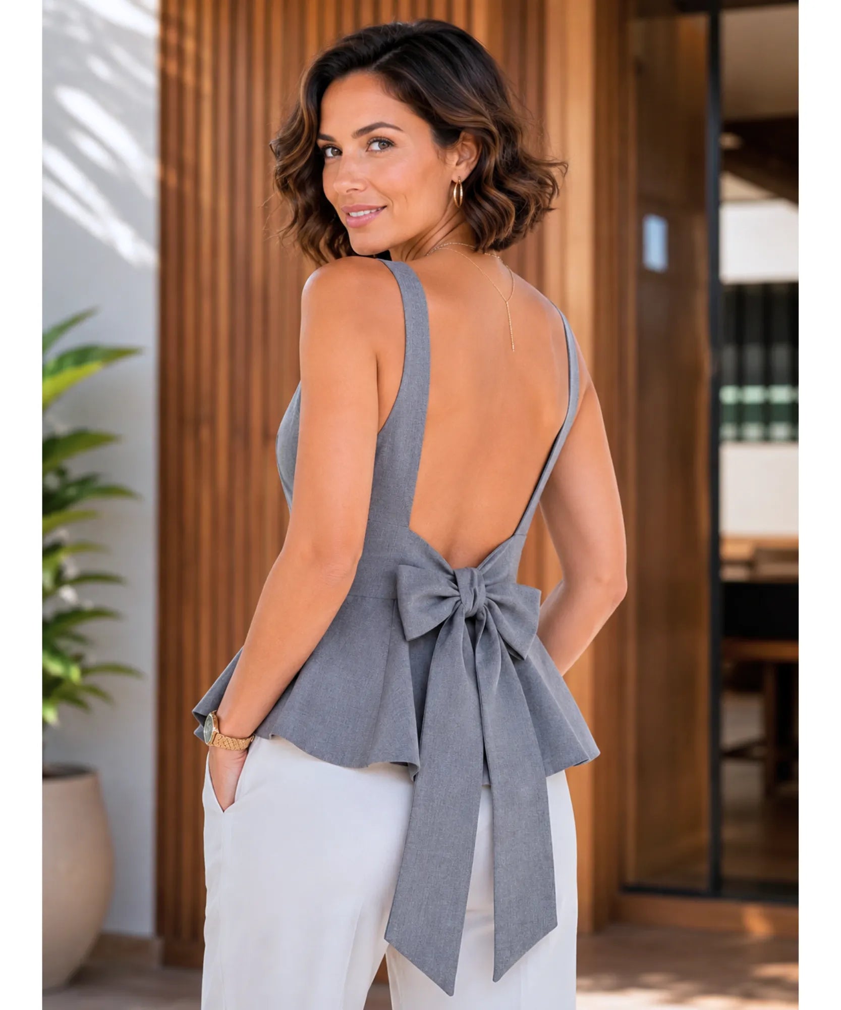 Heather gray open back peplum top with a wide bow, back view