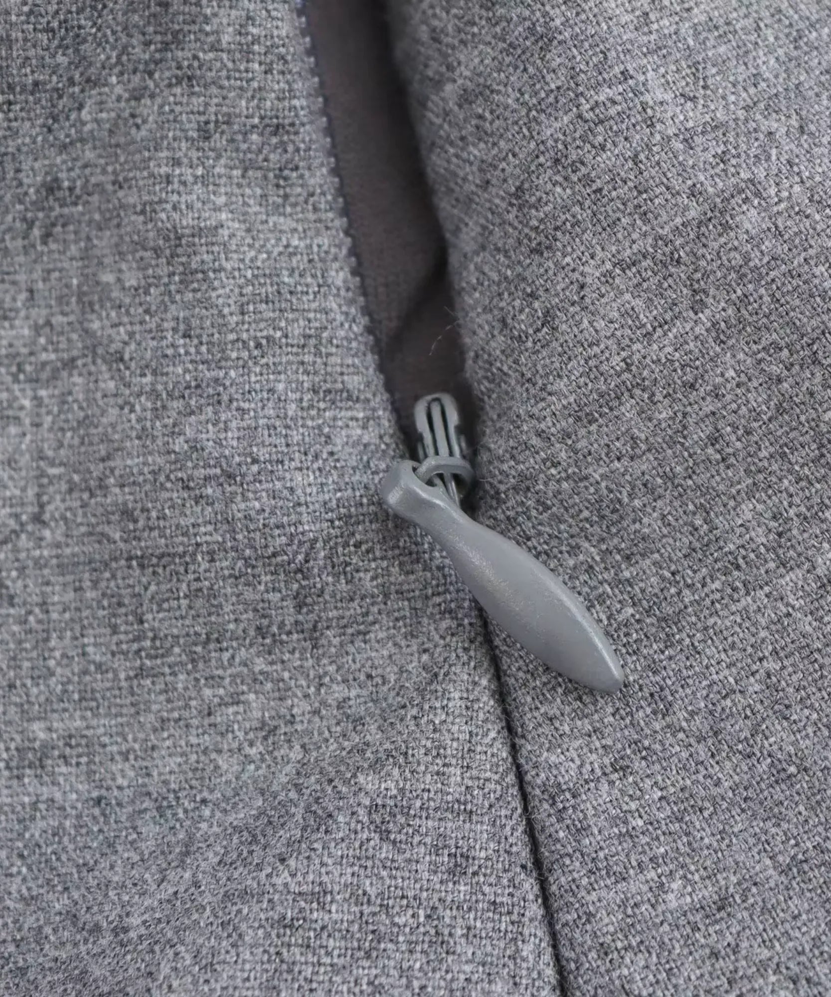 Invisible side zip detail on a heather gray peplum top