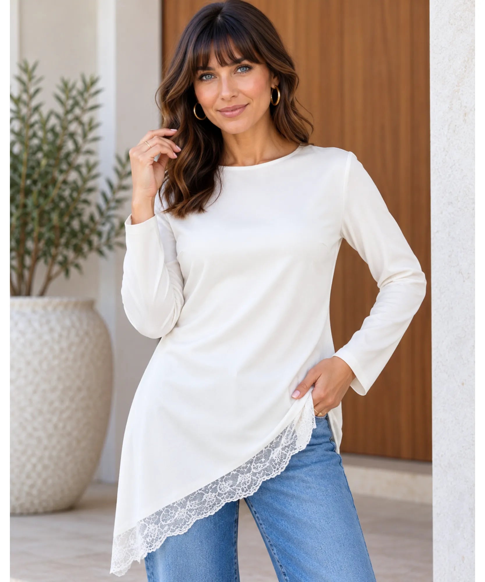 Women's asymmetrical top with lace trim and long sleeves in white