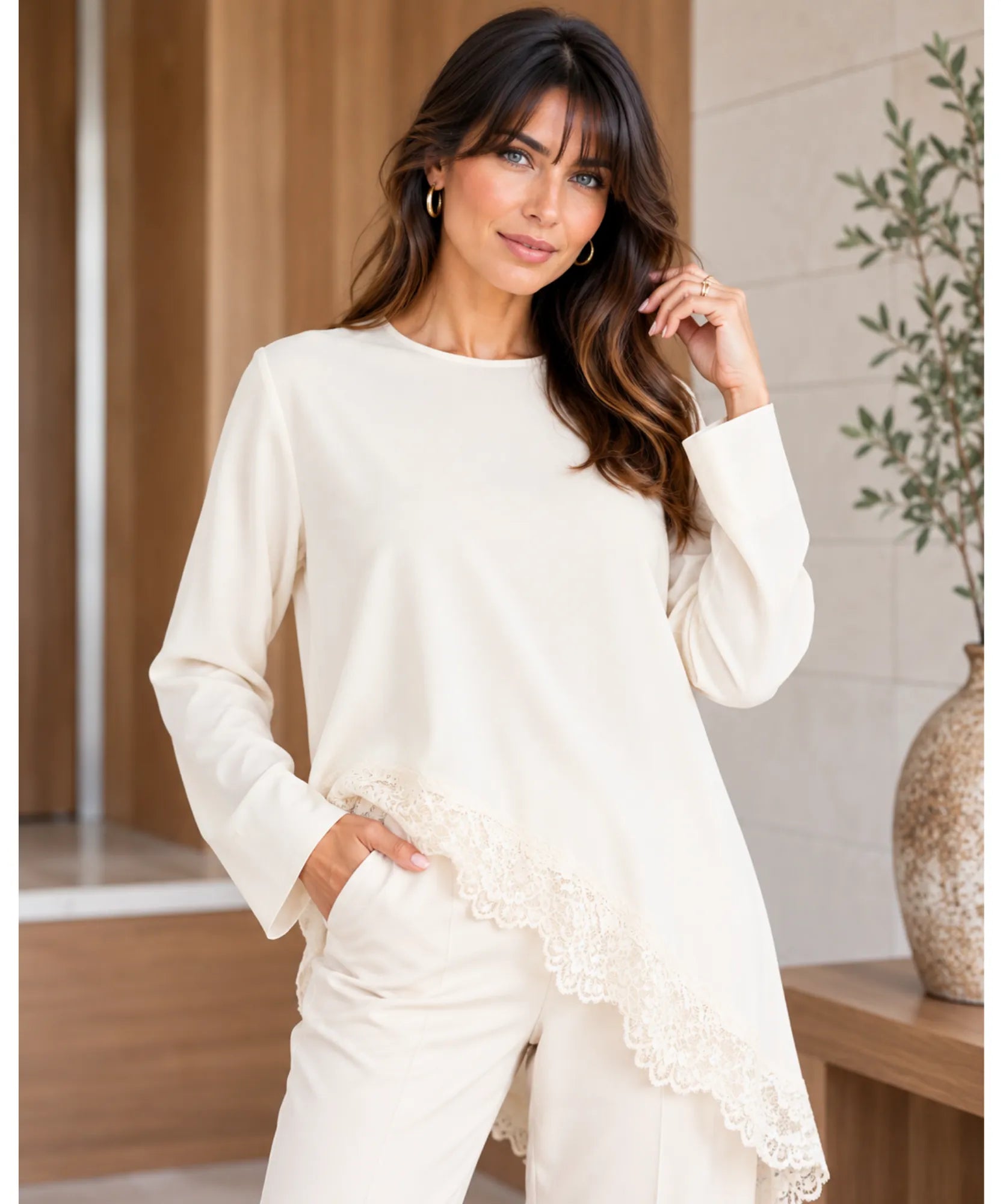 Women's asymmetrical top with lace trim and long sleeves in ivory