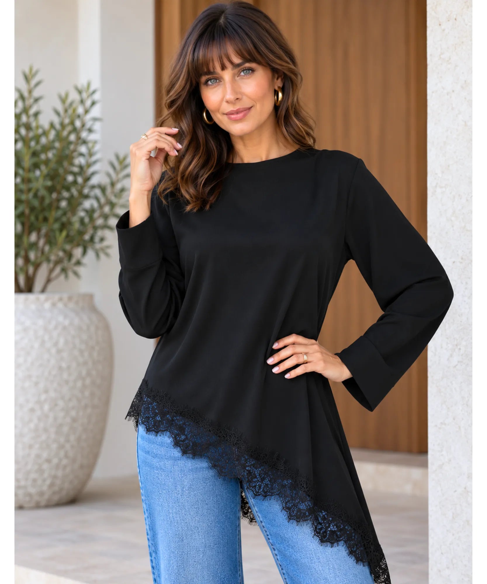 Women's asymmetrical top with lace trim and long sleeves in black