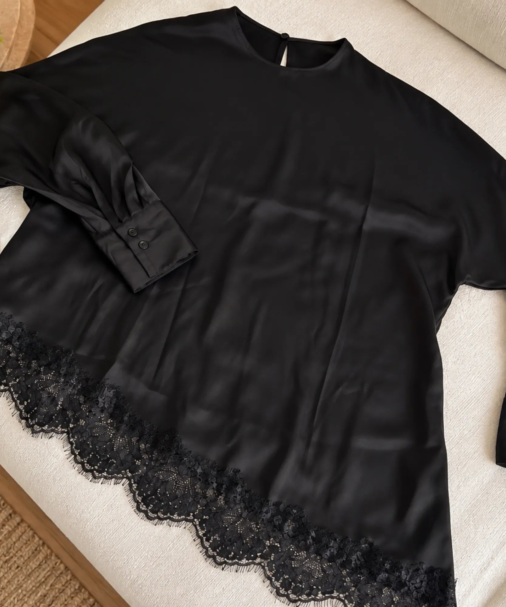 Black asymmetrical top, lace hem detail