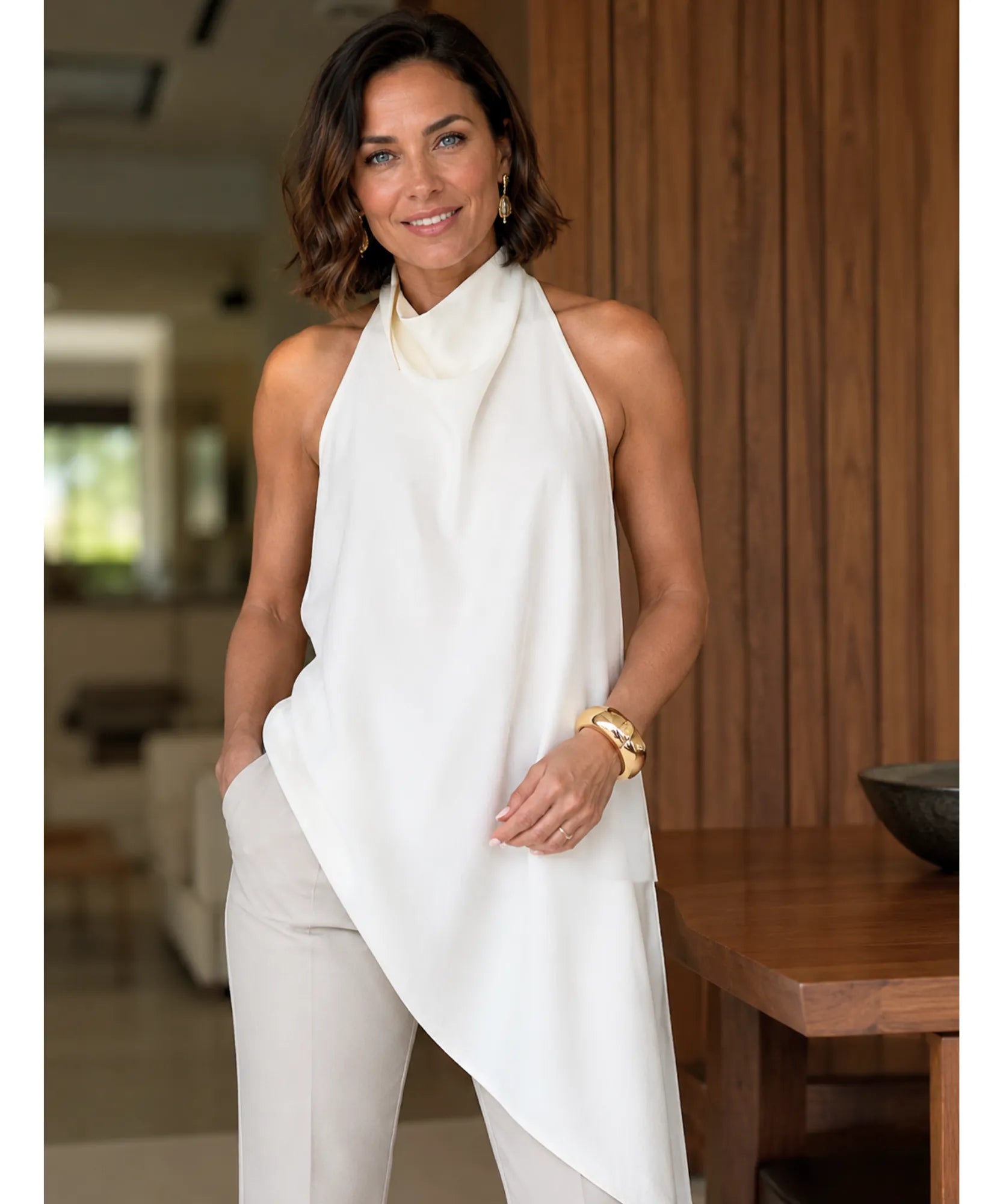 Ivory satin cowl neck halter top styled with ivory trousers