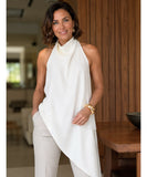 Ivory satin cowl neck halter top styled with ivory trousers