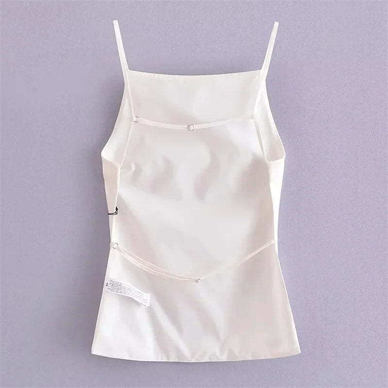 Flat lay back view of white top with open back and two thin adjustable straps