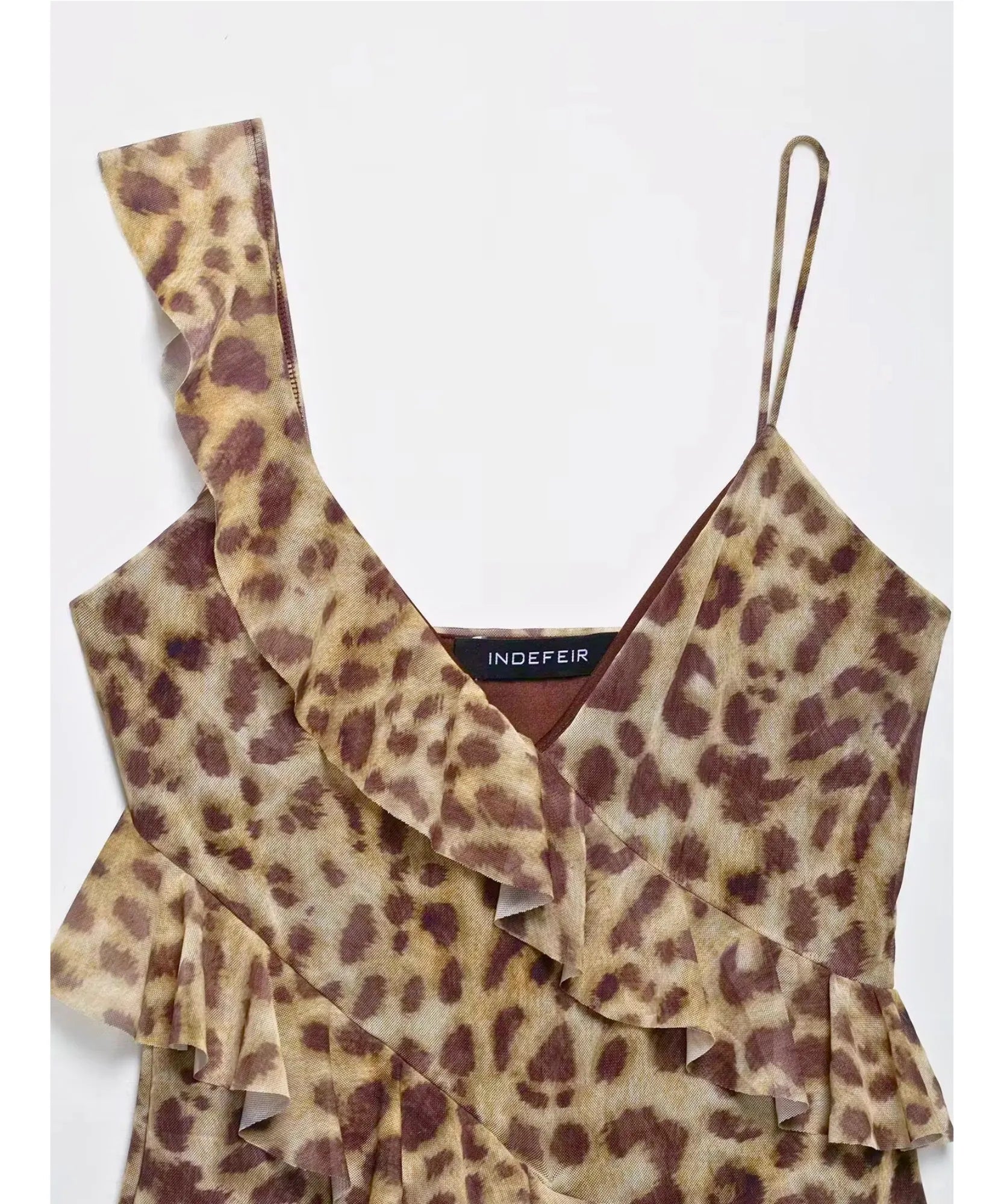 Flat lay of a leopard print ruffle top with thin strap