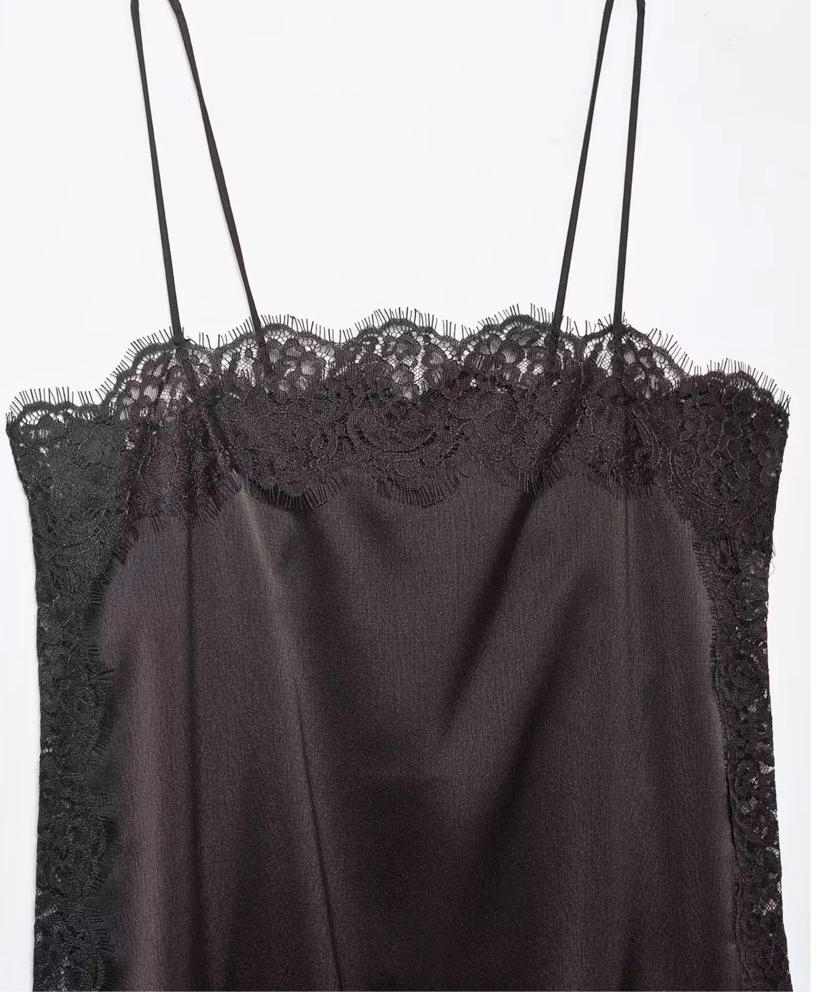 Close-up of dark brown satin cami top with black lace neckline and thin straps