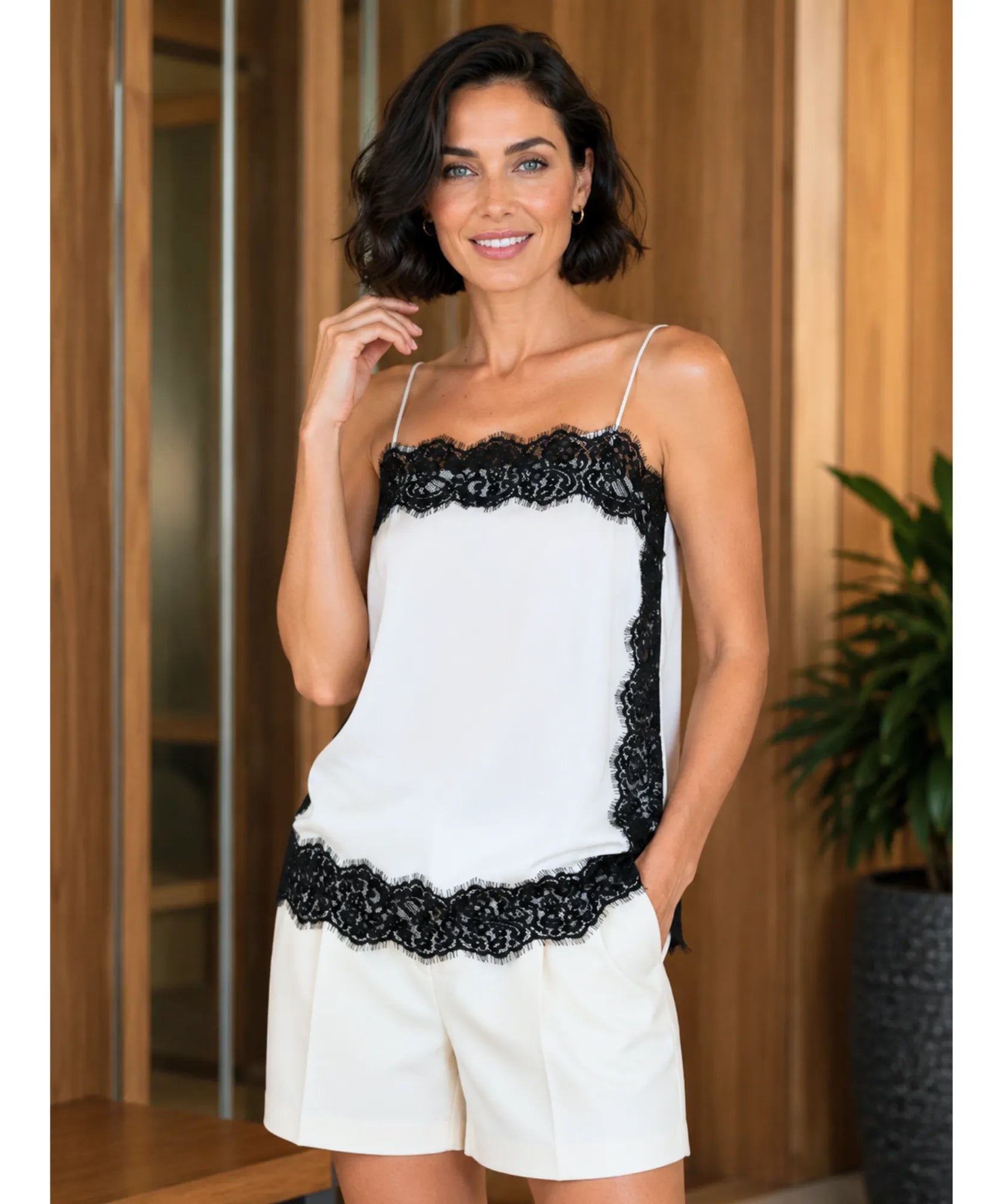 Ivory satin cami top with black lace trim styled with white shorts