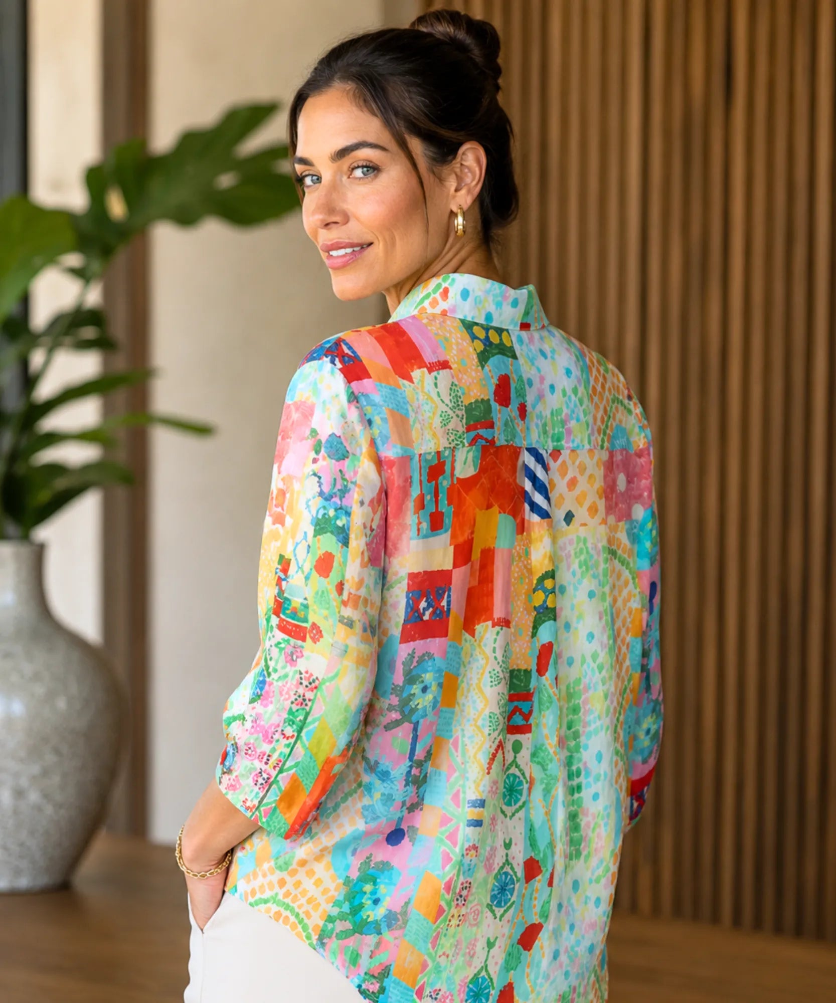 Back view of a women's linen shirt with aqua patchwork print