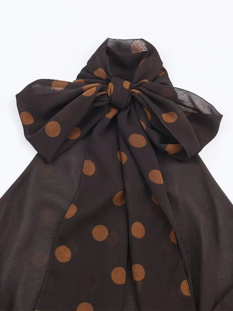 Brown polka dot halter top styled with light trousers